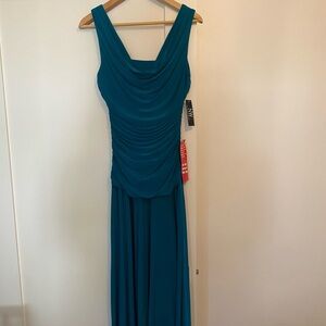 Party holiday Floor length form fitting draped neck evening gown.